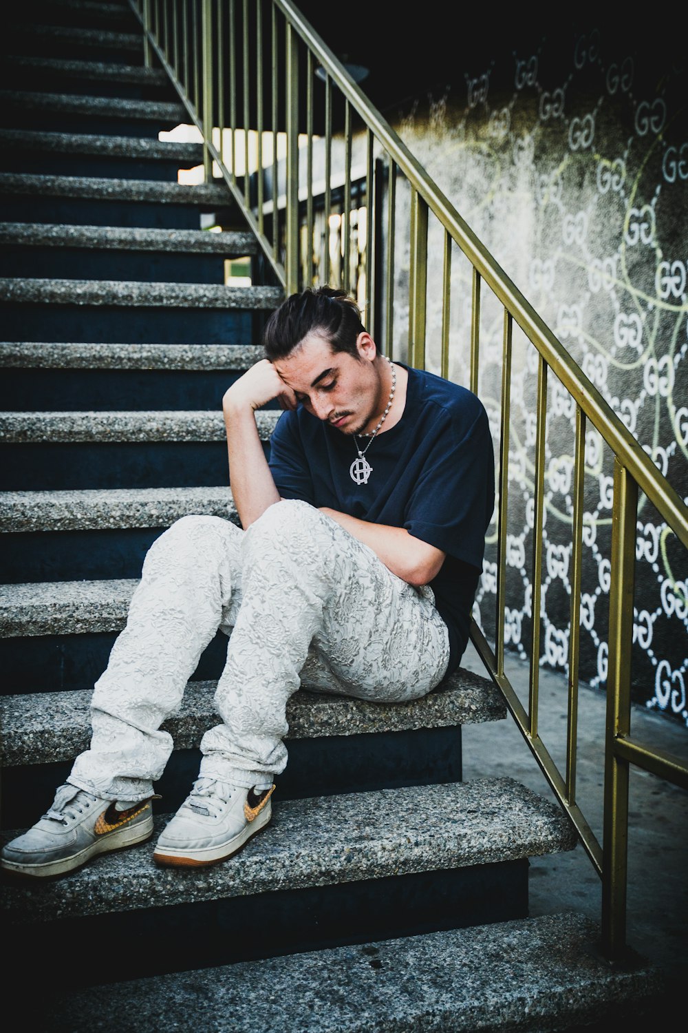 woman in black shirt and gray pants sitting on stairs