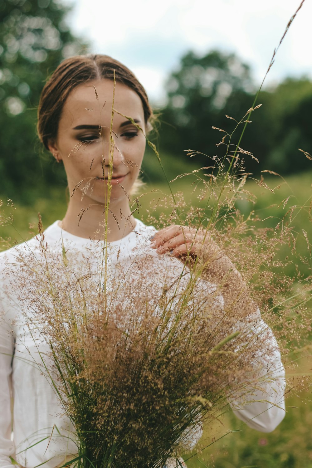 a woman standing in a field of tall grass