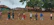 Volunteers distributing medicines and health supplies in a rural community setting.