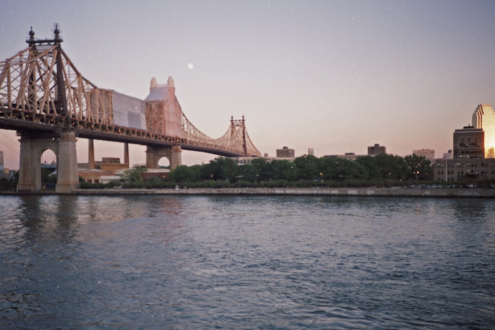 brown concrete bridge over body of water during daytime