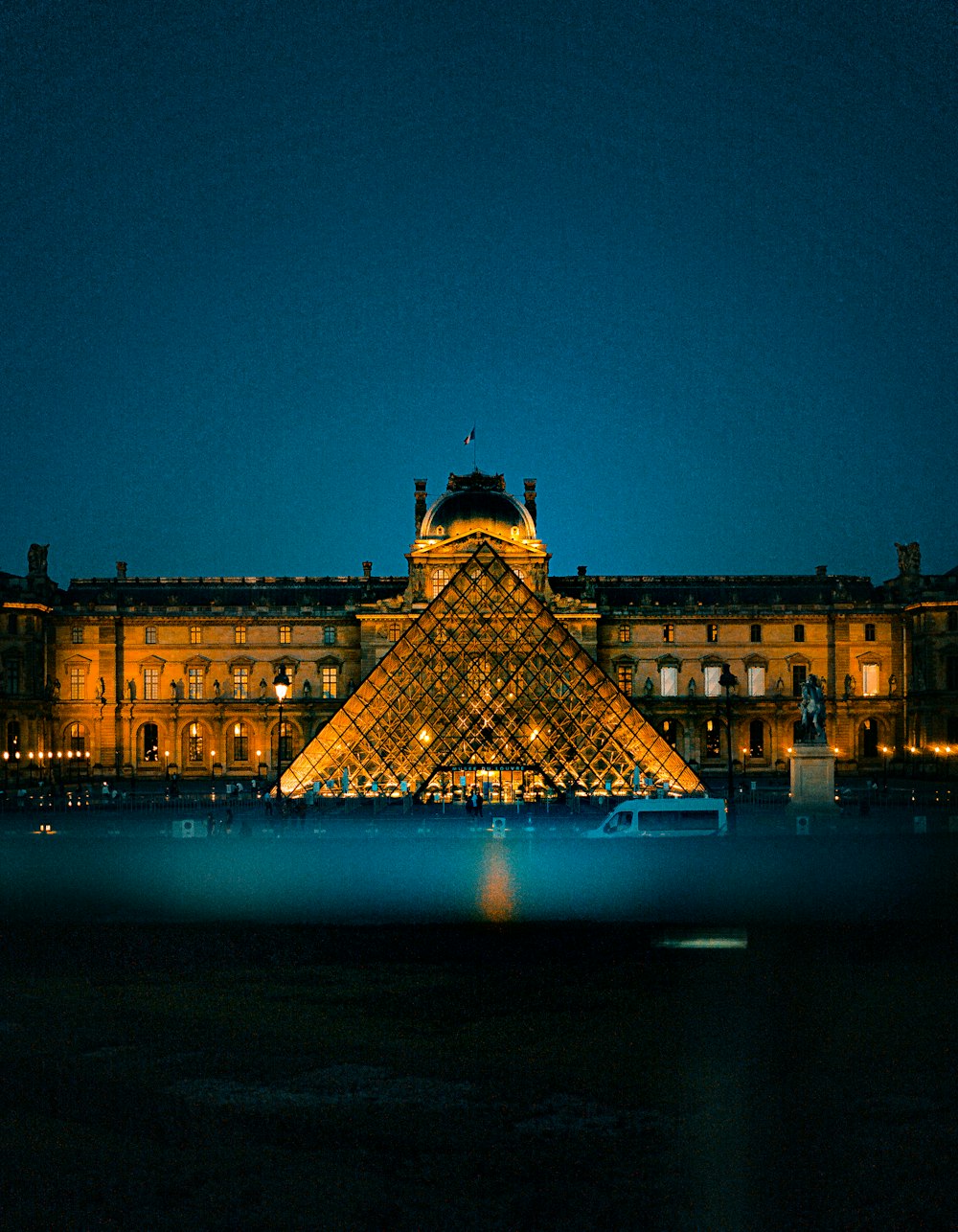 brown concrete building near body of water during night time