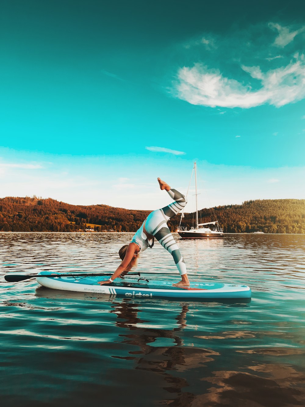 woman in blue and white bikini riding on white surfboard during daytime