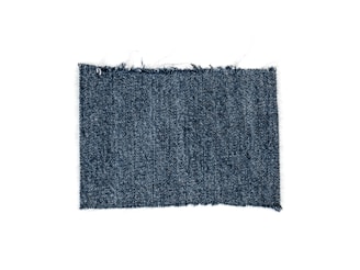 A rectangular piece of blue denim fabric with a textured, woven pattern and slightly frayed edges.