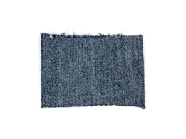 A rectangular piece of blue denim fabric with a textured, woven pattern and slightly frayed edges.