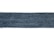 A rectangular strip of blue denim fabric with a textured pattern. The edges appear slightly frayed, and the denim has a deep blue color with a subtle variation in the weave.