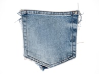 Soft, worn-in denim pieces layered with delicate lace trims, ready for crafting.