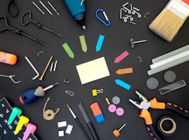 assorted color plastic tools on gray wooden table