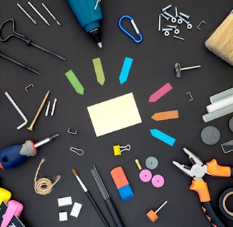 assorted color plastic tools on gray wooden table