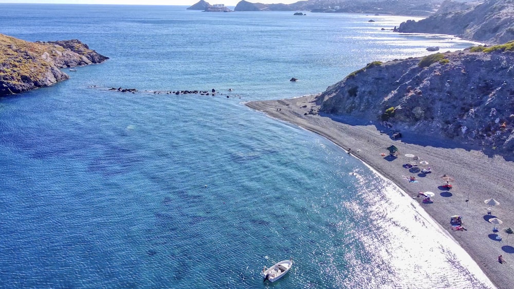 white and black boat on blue sea during daytime