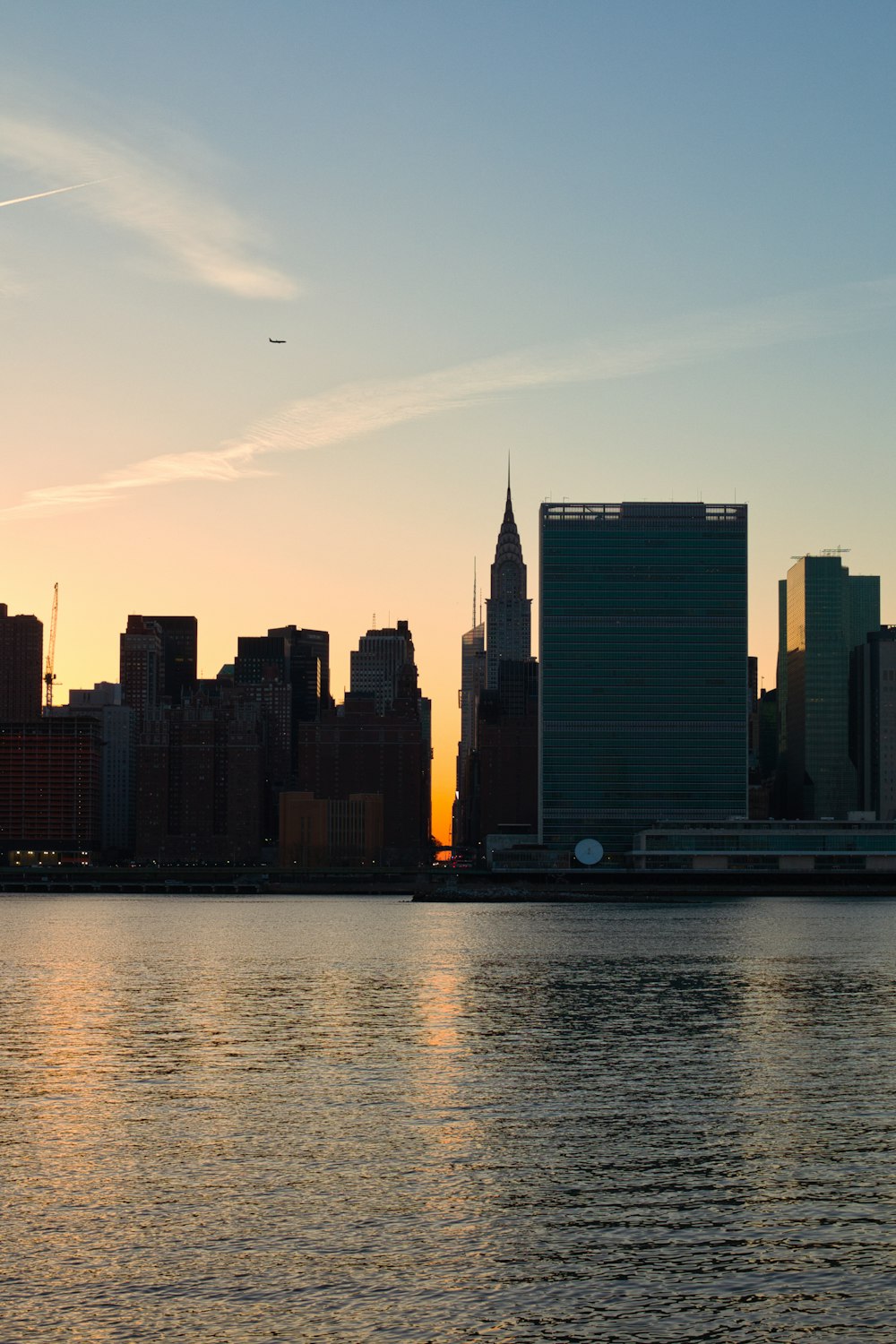 city skyline across body of water during daytime