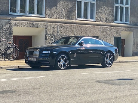 A sleek car ready for a long-term rental, parked near a cozy Malang neighborhood.