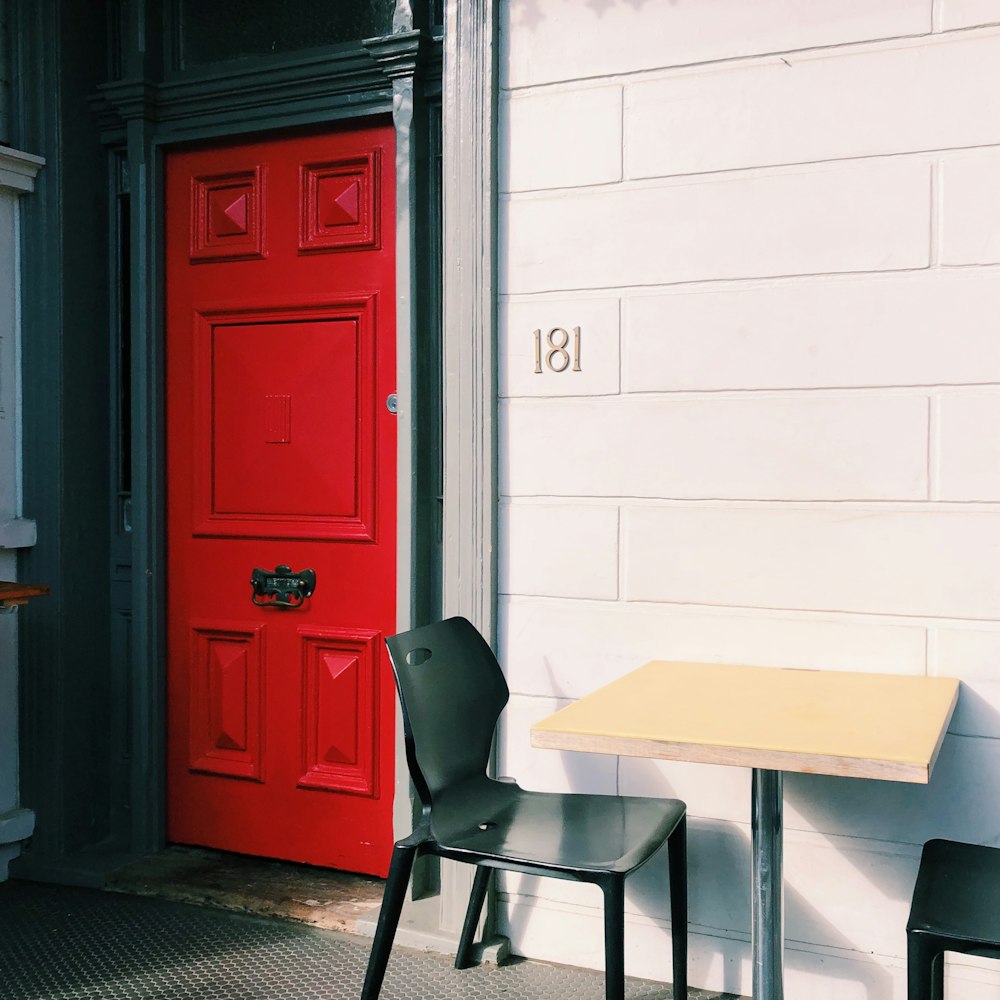 black and white table beside brown wooden door