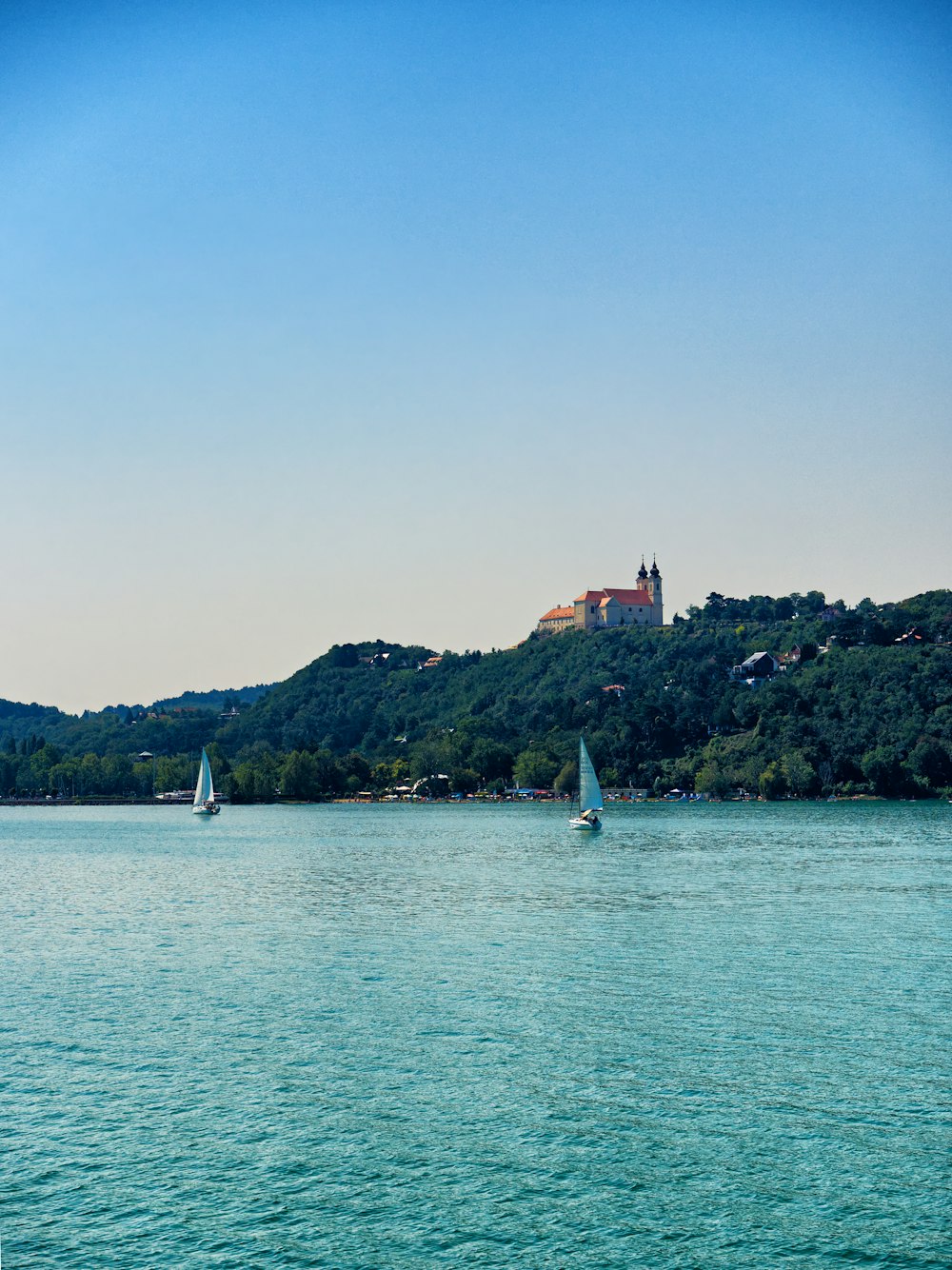 white sail boat on sea during daytime