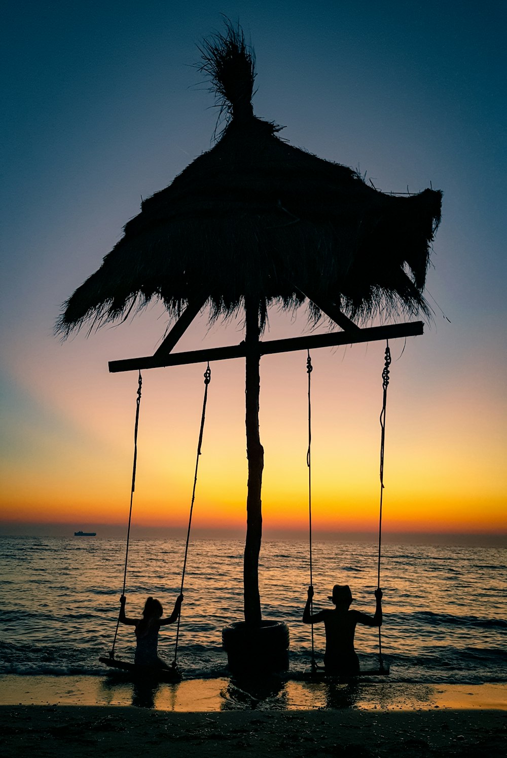 silhouette of hammock during sunset