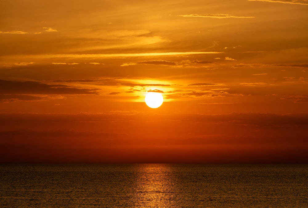 body of water during sunset