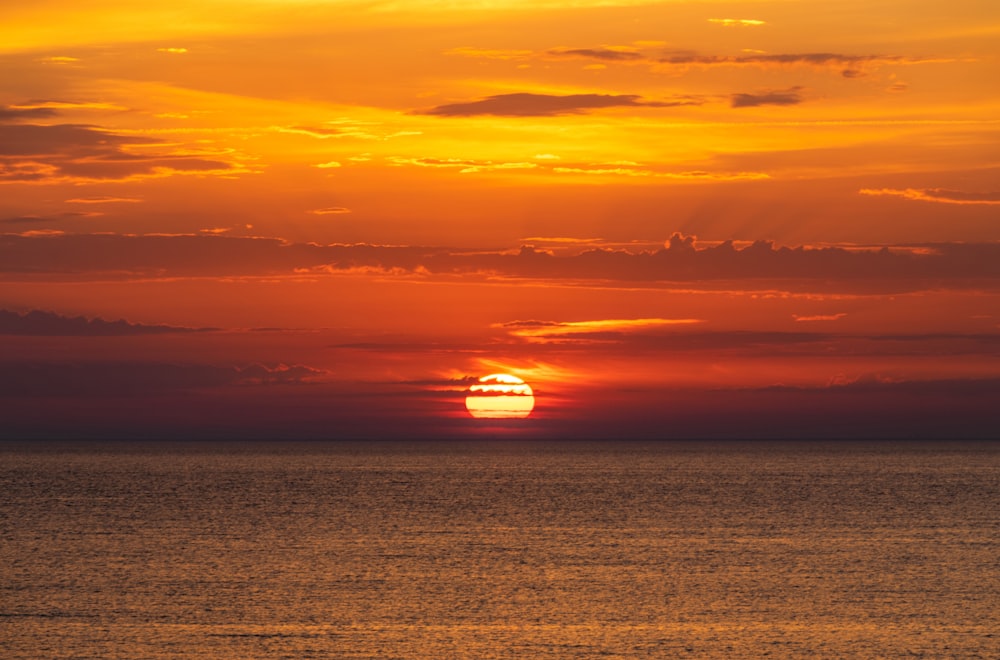 body of water during sunset