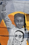 A close-up portrait of an African American woman with a determined expression, standing in front of a vibrant mural symbolizing hope and strength.