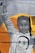 A mural depicts a young African American girl raising her fist in a gesture of power and solidarity. Her facial expression is serious and resolute. She has long braids and is wearing a sweatshirt that bears the face of a man with the words 'I CAN'T BREATHE' written across his mask. The background is an orange circle that contrasts with the monochrome tones of the mural.