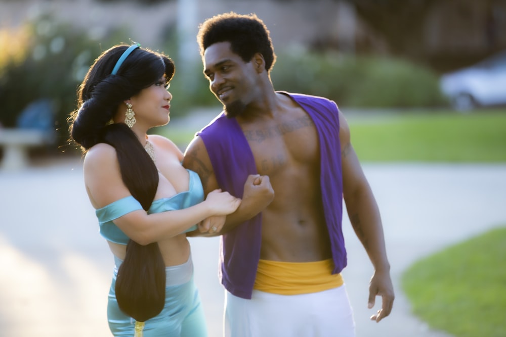 man in purple tank top and woman in white tank top