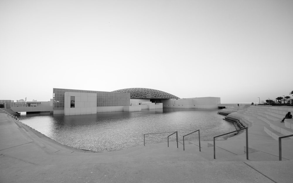 white concrete building near body of water