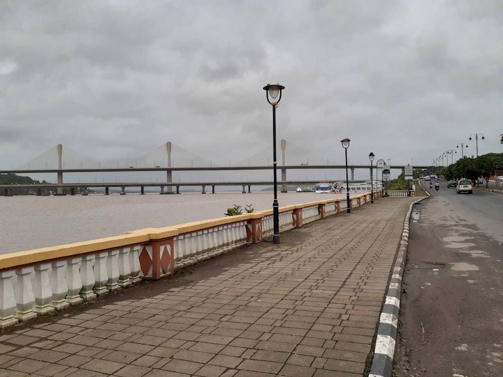 brown wooden bridge over body of water during daytime