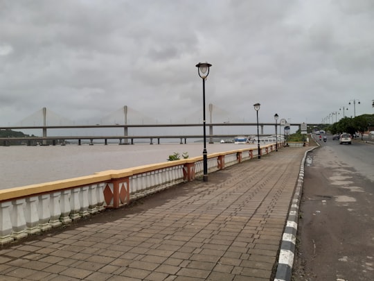 brown wooden bridge over body of water during daytime in Panaji India