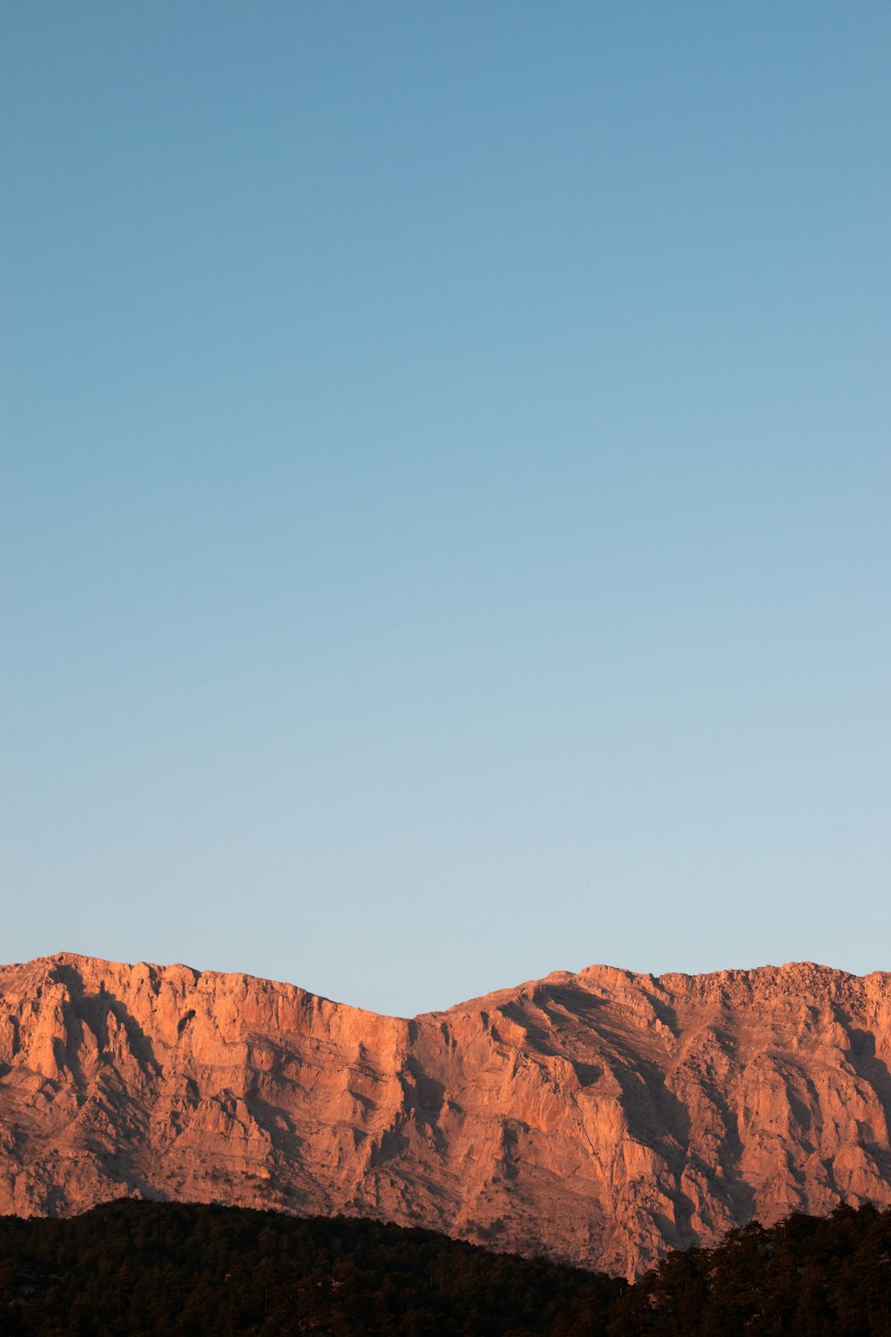 brown rocky mountain under blue sky during daytime