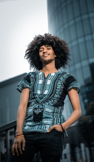 Portrait of a confident African entrepreneur standing in front of a luxury office building, embodying leadership.
