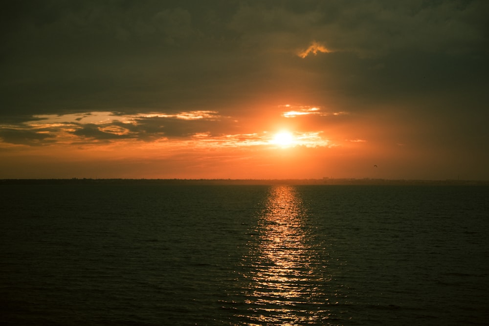 body of water during sunset