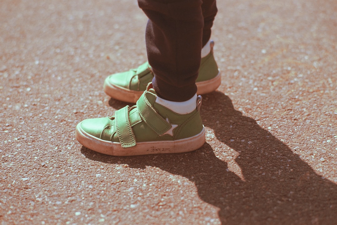 person wearing green and white nike sneakers