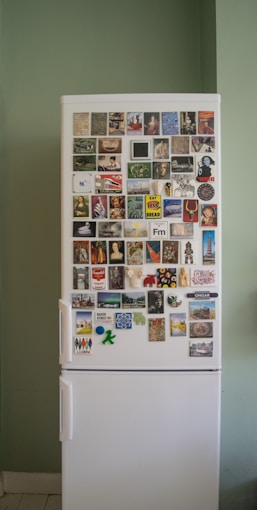 white top mount refrigerator with stickers