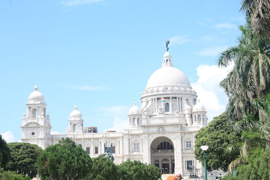 white dome building under blue sky during daytime in Victoria Memorial India