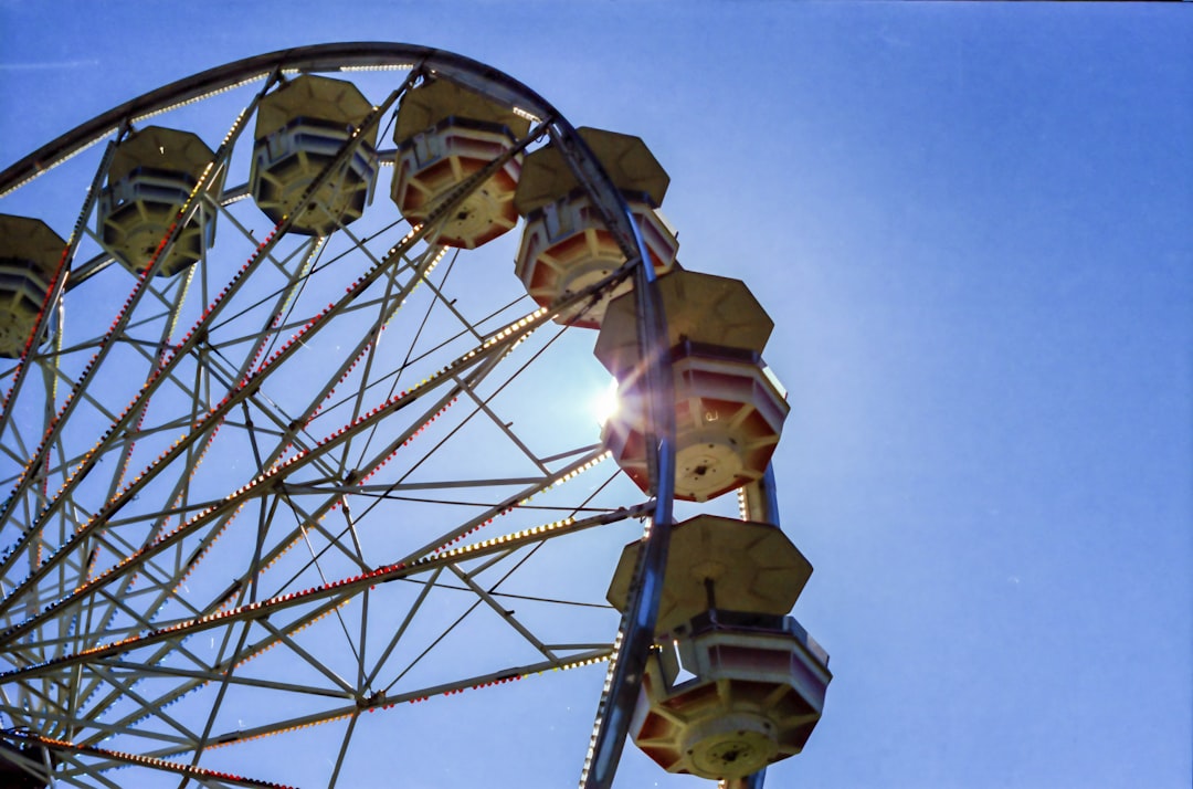 yellow and brown ferris wheel under blue sky during daytime