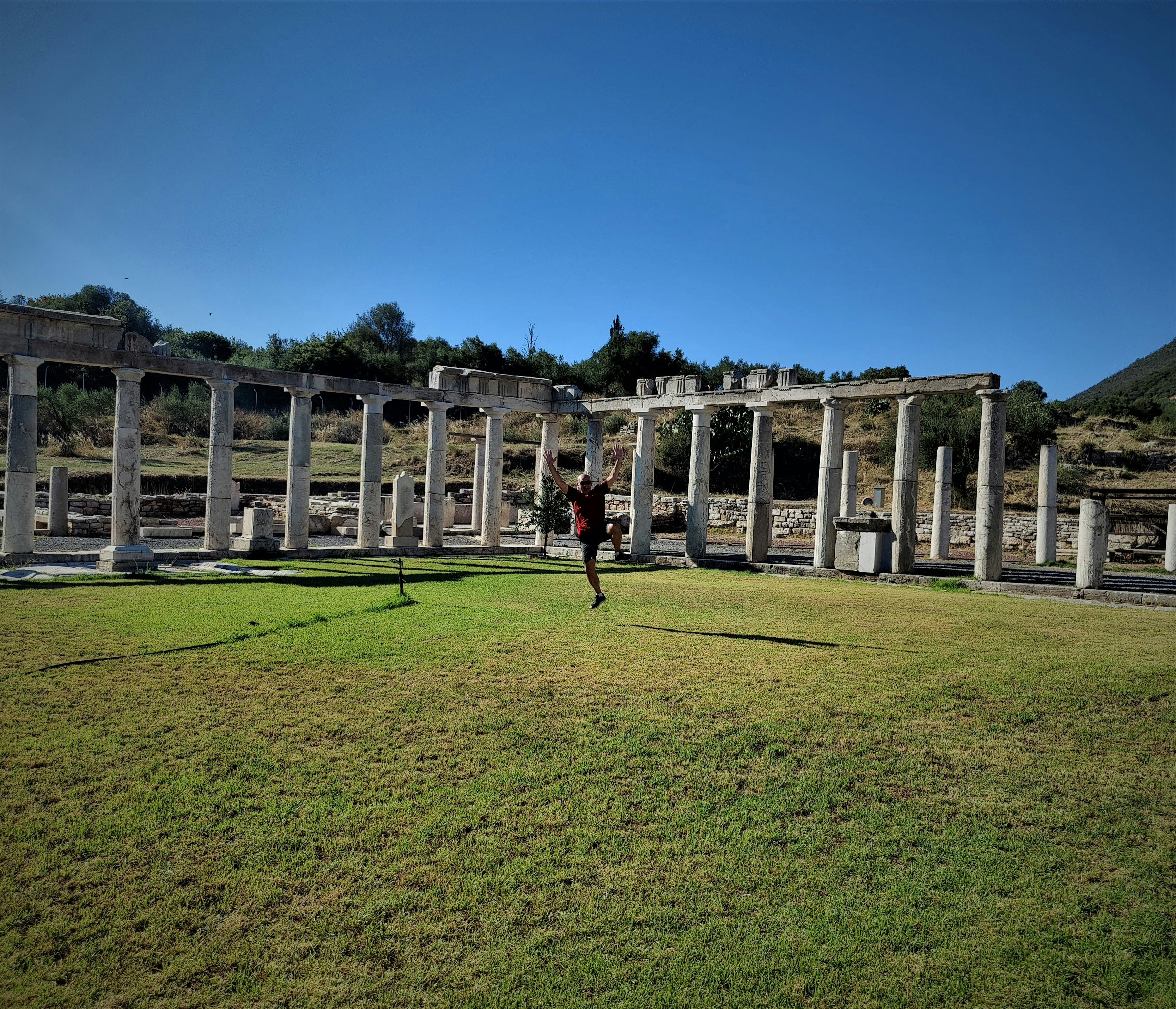 people walking on green grass field near white concrete building during daytime