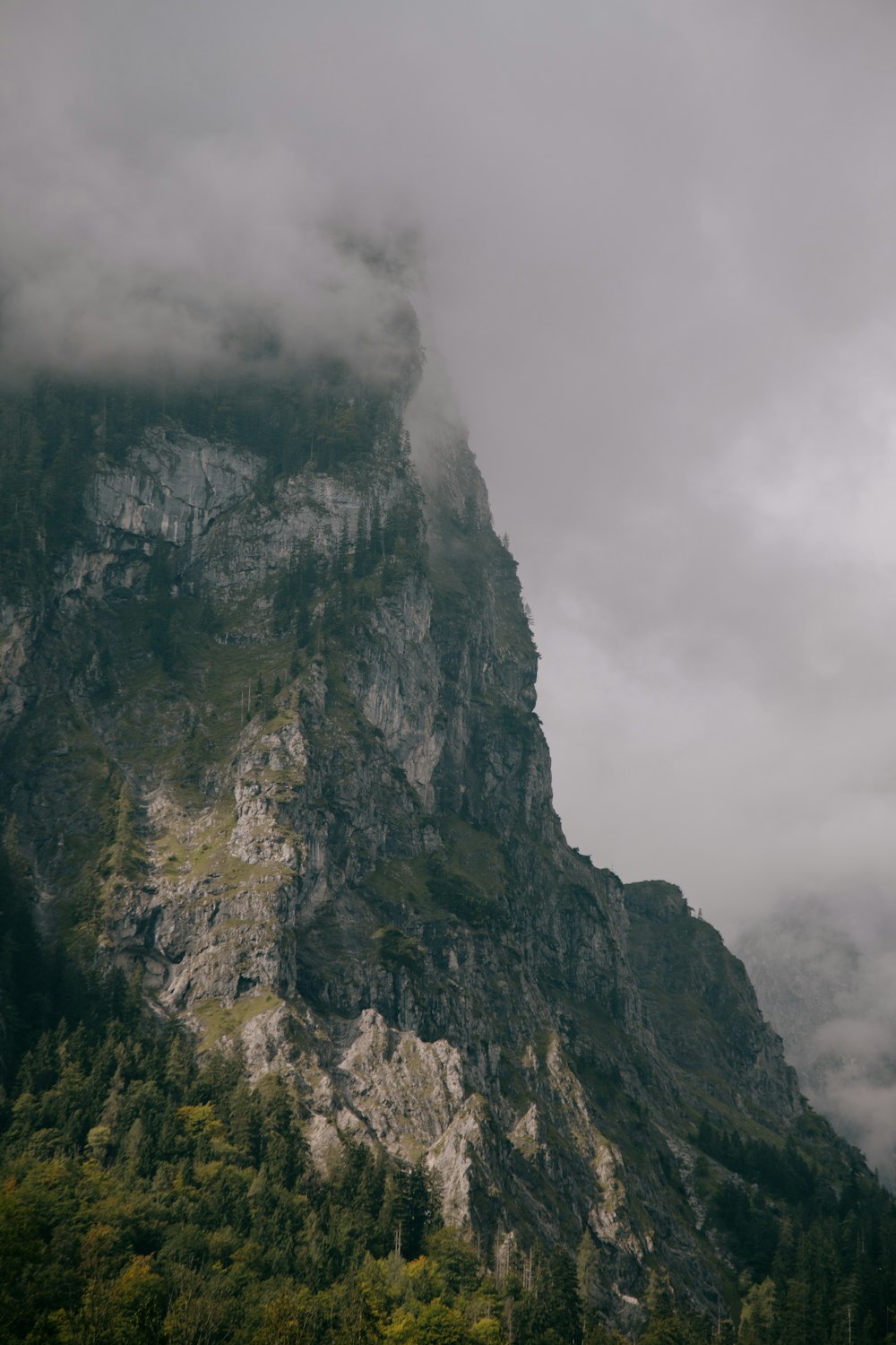 gray and black rocky mountain under white cloudy sky during daytime