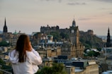 woman in white shirt looking at the city during daytime