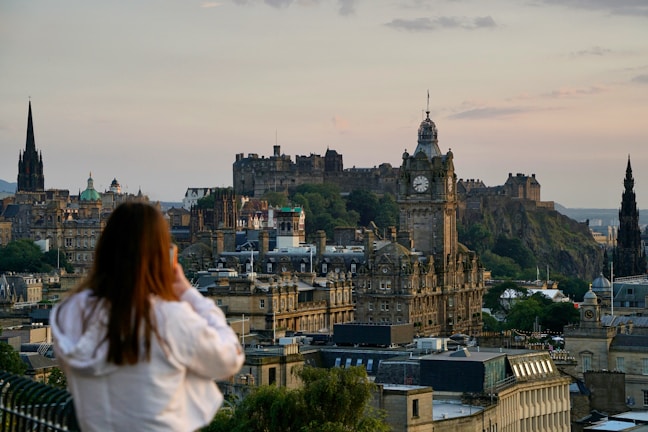 woman in white shirt looking at the city during daytime