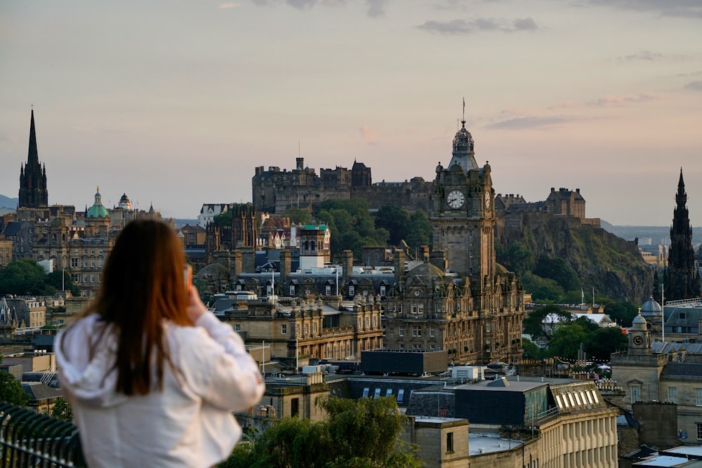 woman in white shirt looking at the city during daytime