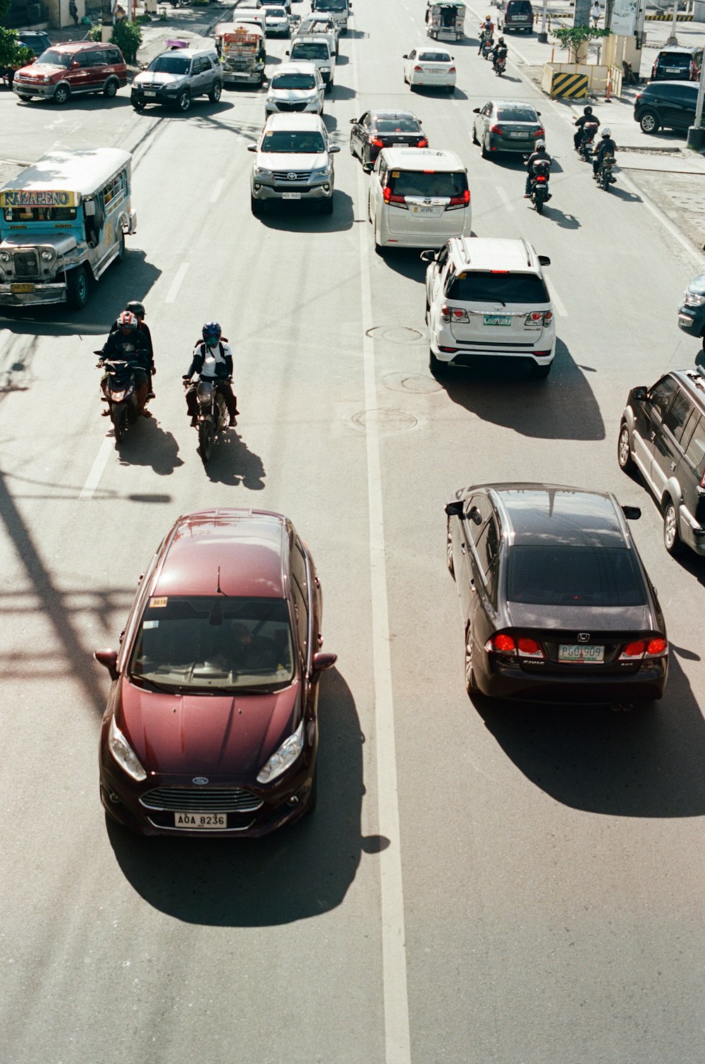 red honda car on road during daytime