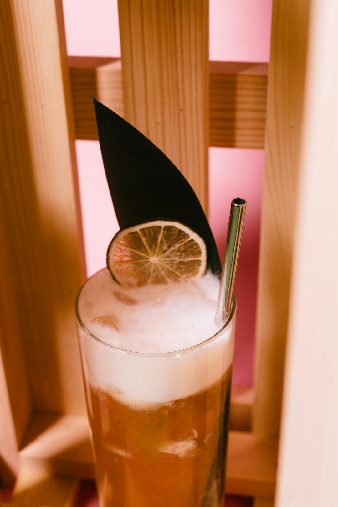 clear drinking glass with ice and black straw