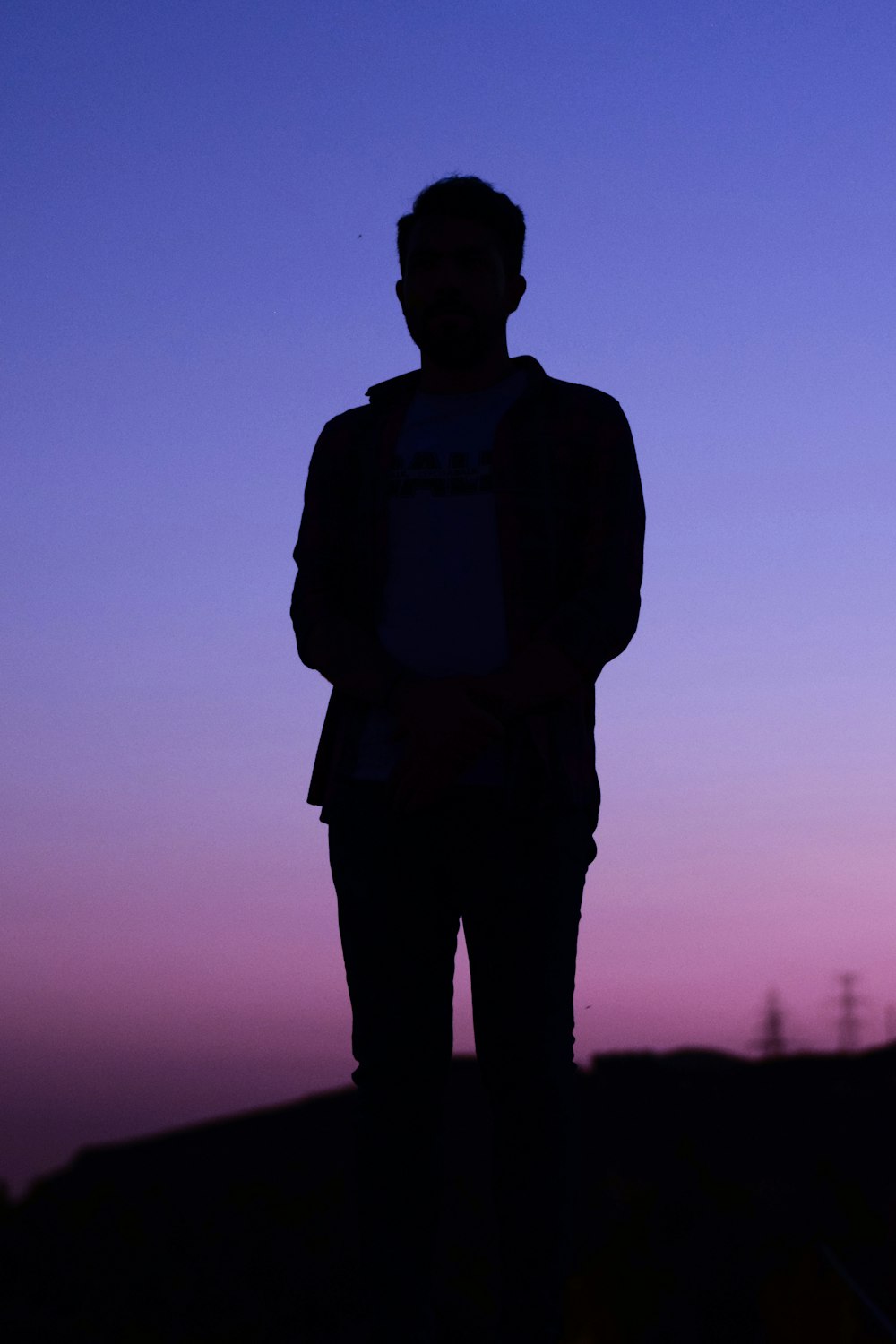 silhouette of man standing during sunset