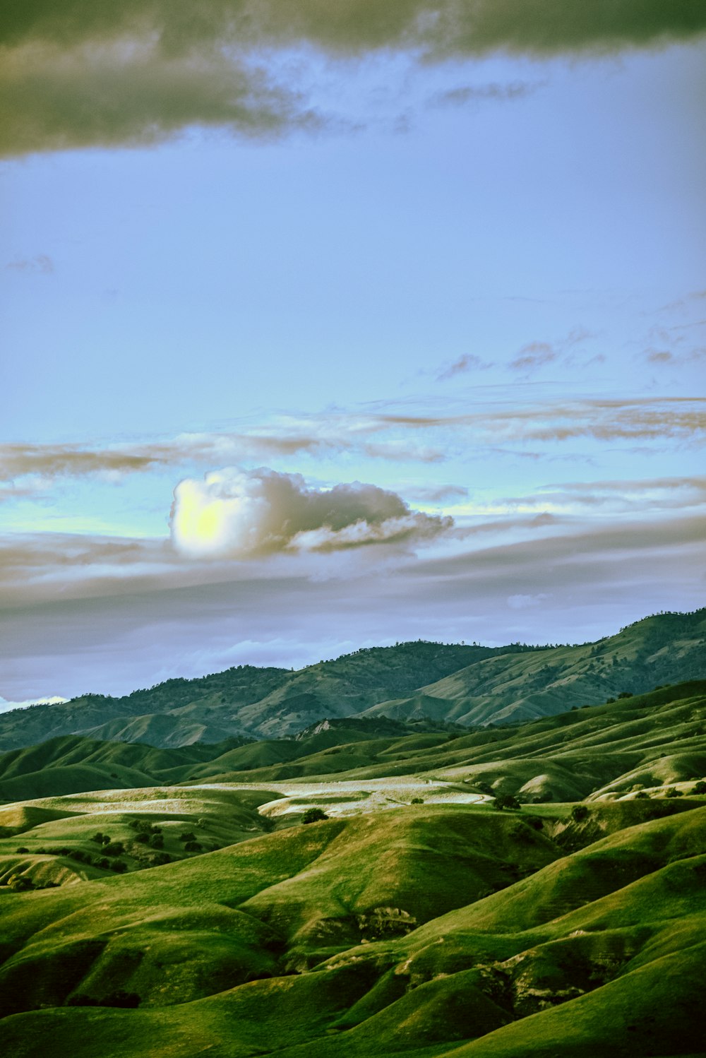 green mountains under white clouds during daytime