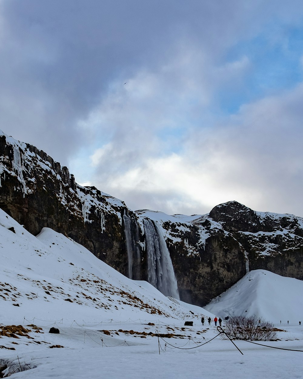 snow covered mountain under cloudy sky during daytime