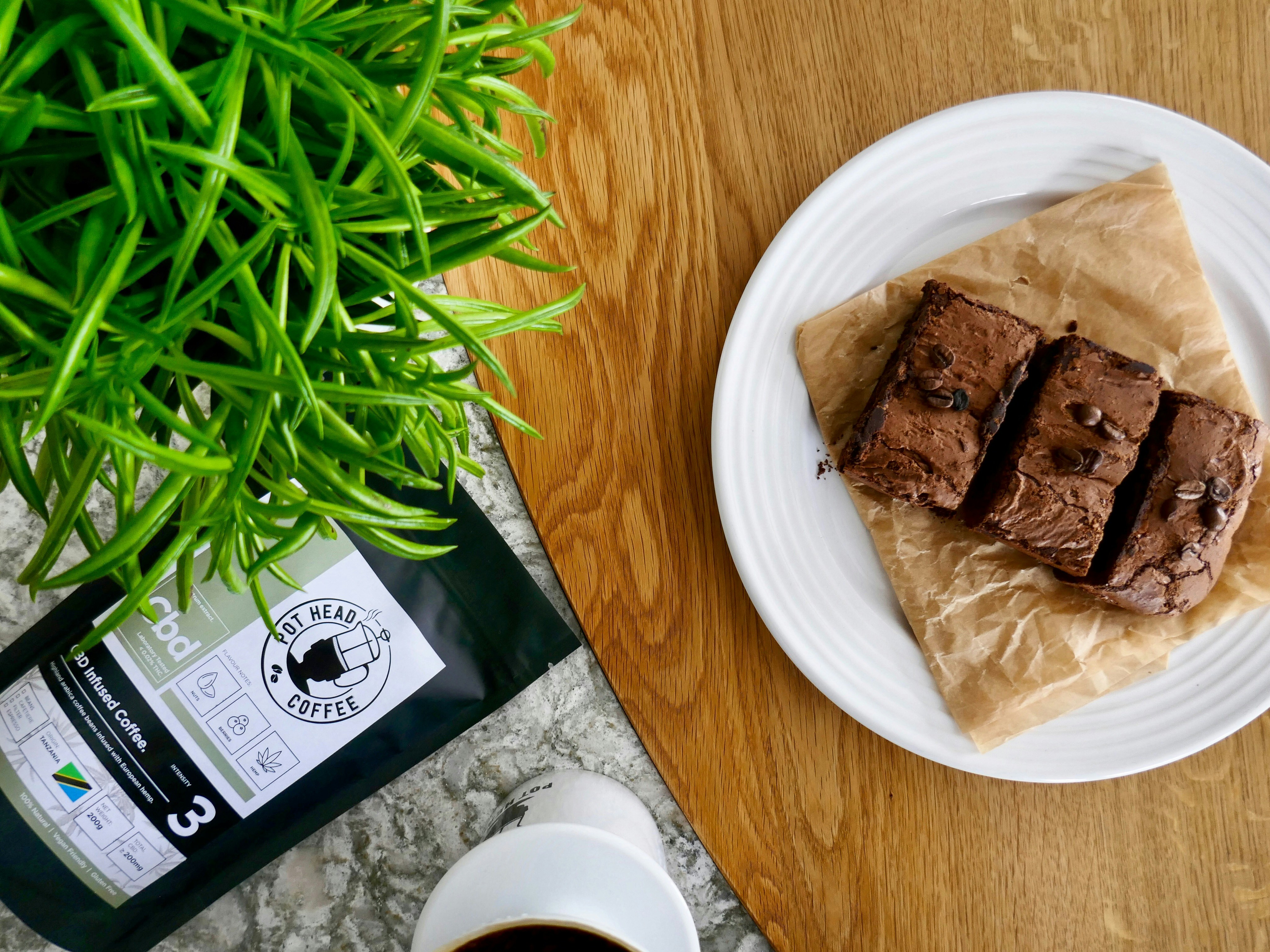 brown and white plastic pack on white ceramic plate, CBD Coffee Brownies