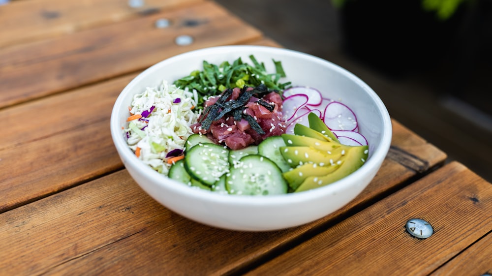 sliced cucumber on white ceramic bowl