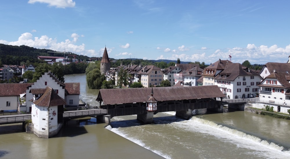 brown and white concrete houses near river under blue sky during daytime