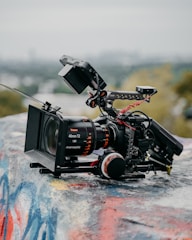 black video camera on white and blue surface