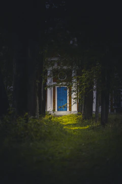 white and blue wooden house on green grass field