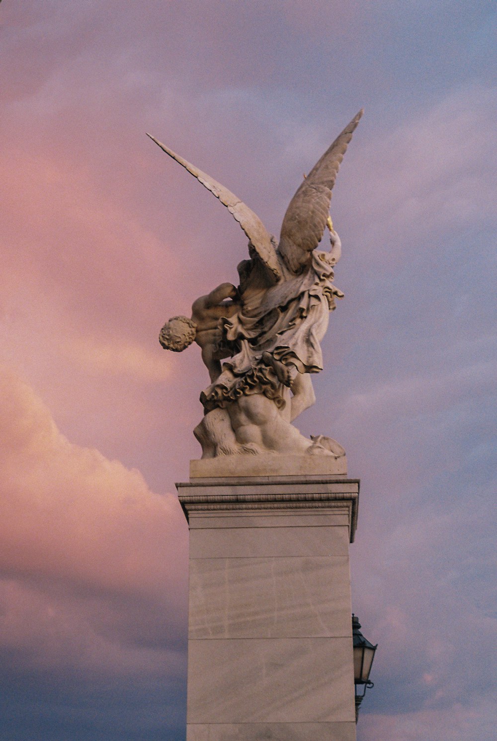 gray concrete statue under cloudy sky during daytime