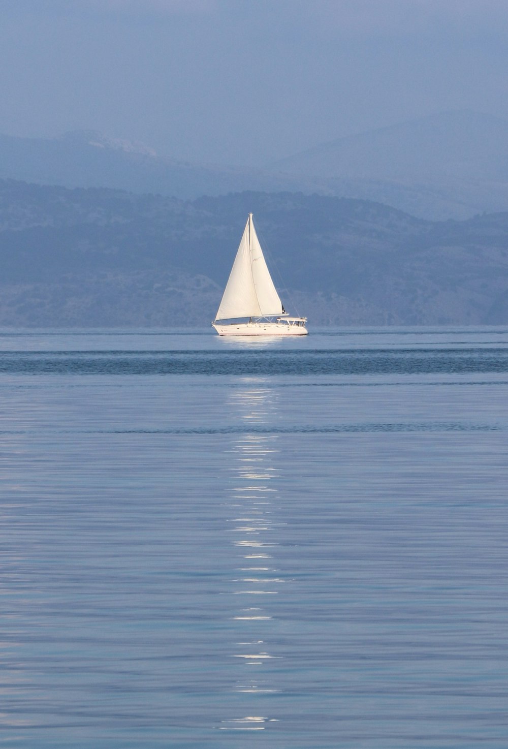 white sailboat on blue sea during daytime